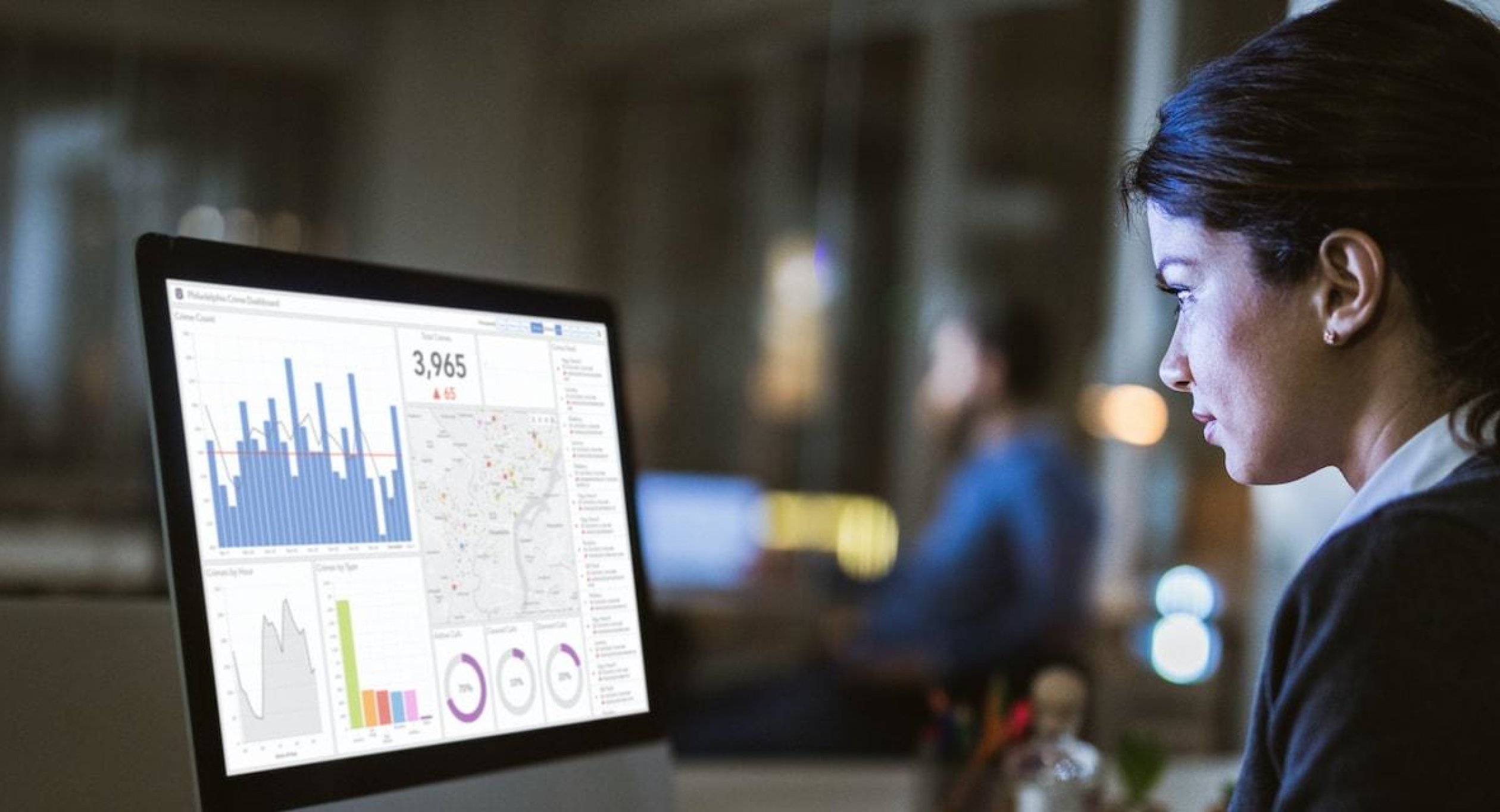 Woman lokoing at business data on computer screen.