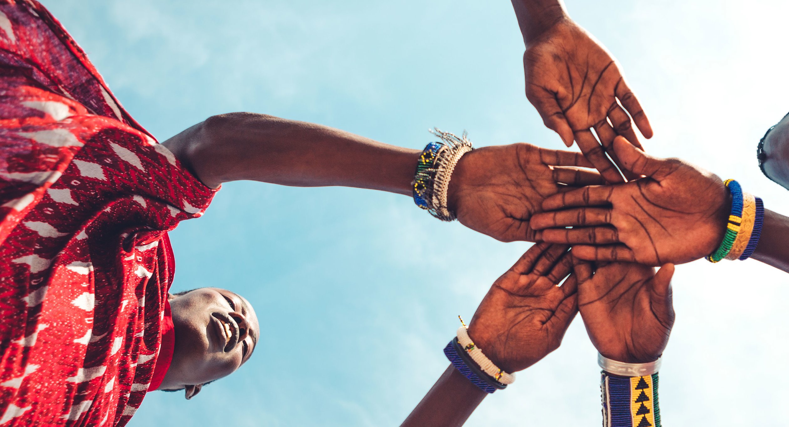 Shot from below of hands being held.