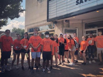 Utica College students stand outside the Uptown Theatre for Creative Arts where they volunteered as part of Pioneer Pitch-In.