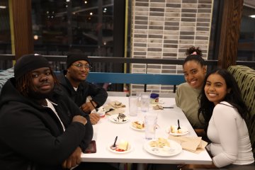 Students gather at a table for the 2024 Holiday Dinner.