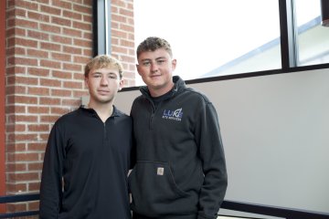 Evan Andrews ’27 and Thaddeus Luke ’27 stand in a stairway.