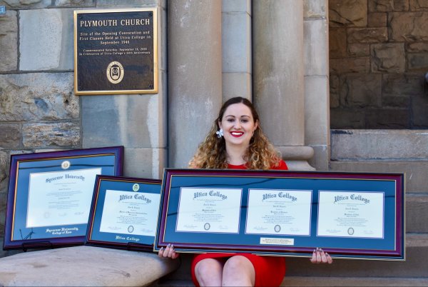 Ann Ciancia sits outside Plymouth Church with her multiple degrees.