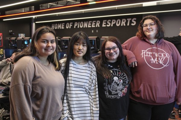 The four members of the first all-female eSports team at Utica University stands shoulder to shouler.