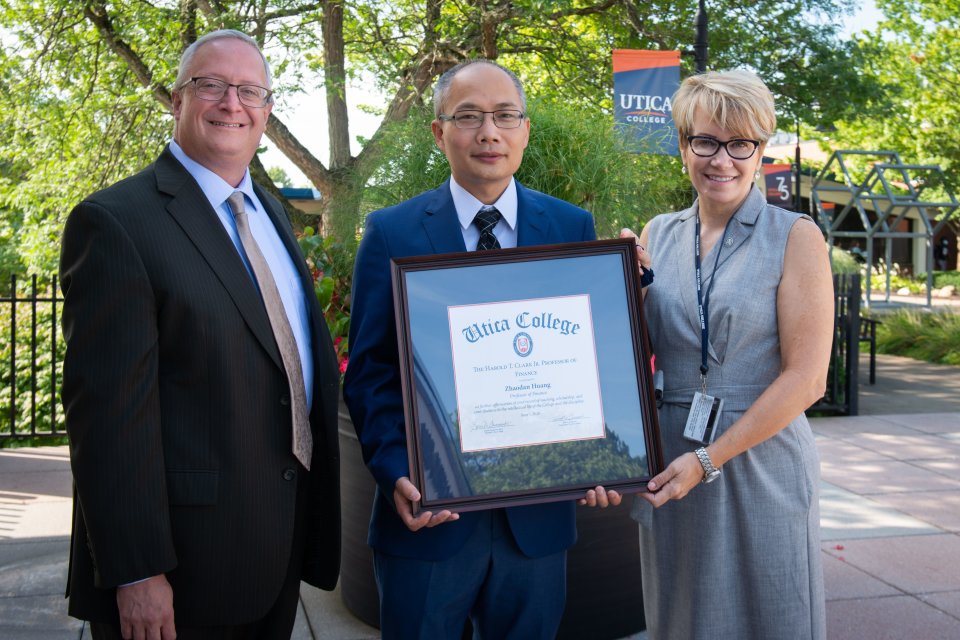 Harold T. Clark Jr. Endowed Professorship award winner Professor Zhadroan Jordan Huang stands with Provost Todd Pfannestiel and President Laura Casamento. 