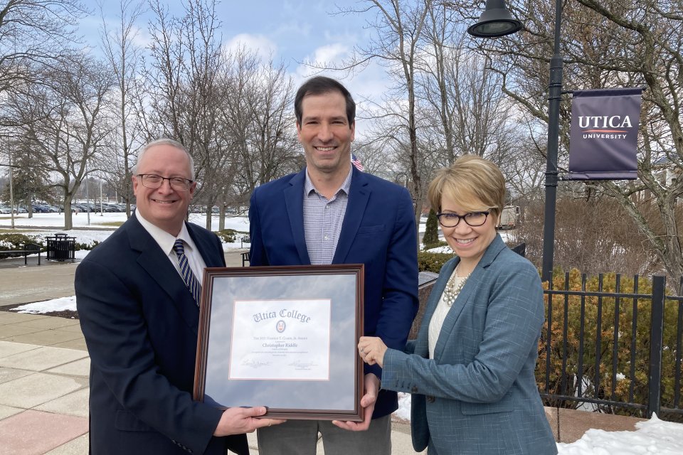 Professor Christopher Riddle receives the prestigious Clark Award, presented by Provost Todd Pfannestiel and President Laura Casamento