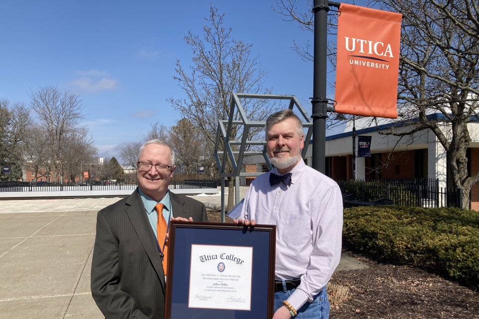 Provost Todd Pfannestiel presents the Paul Young Award to Professor Jeffrey Miller.