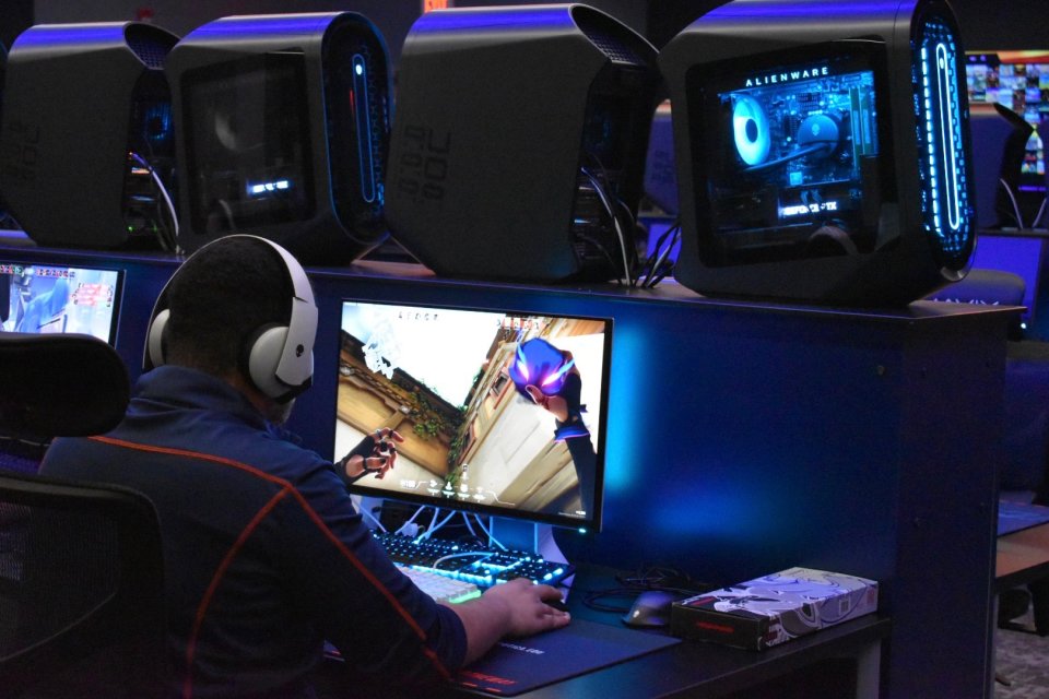 A student sits at a computer screen playing a game as part of Utica University's eSports program.